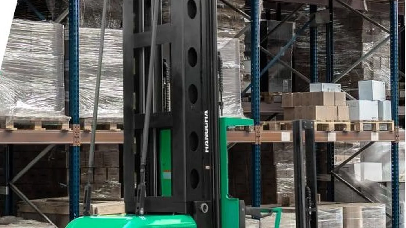 X Series 1.0 to 1.6 tonne man-up trilateral stacker in a VNA warehouse