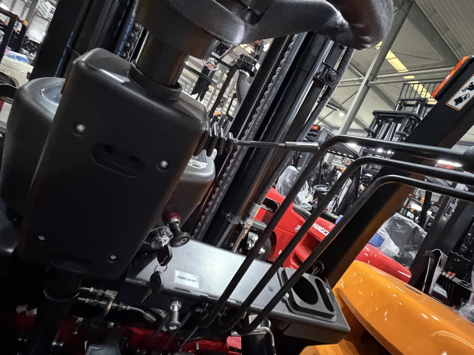 Forklift operator view showing mast hydraulic components and control context