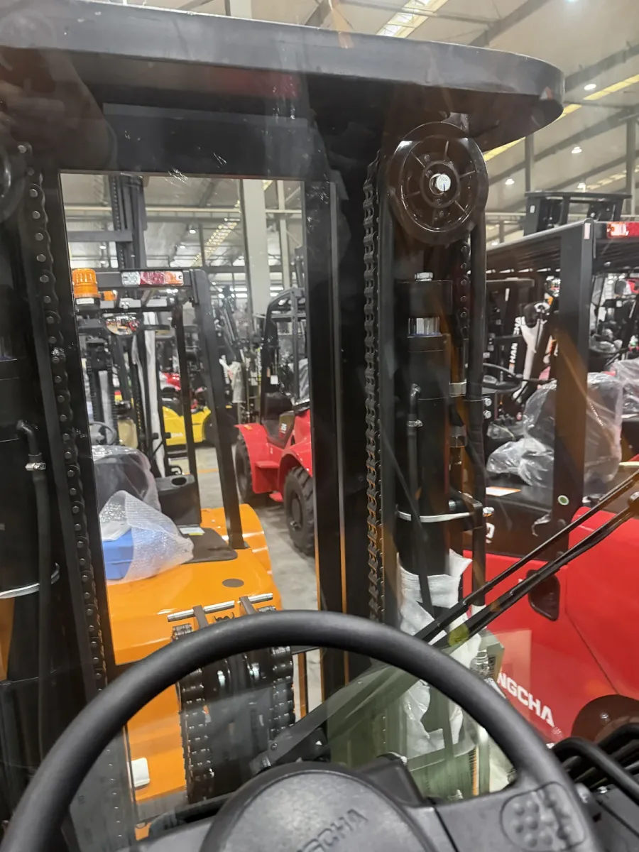 Operator view of a forklift mast and overhead structure showing clearance-critical components