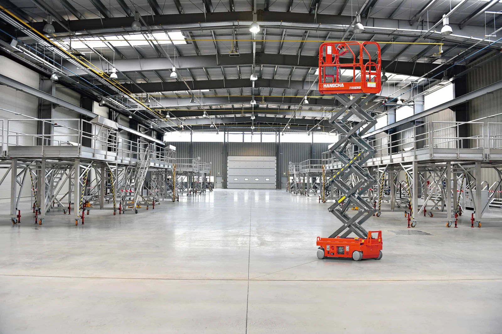 Hangcha mini self-propelled scissor lift raised inside an industrial building